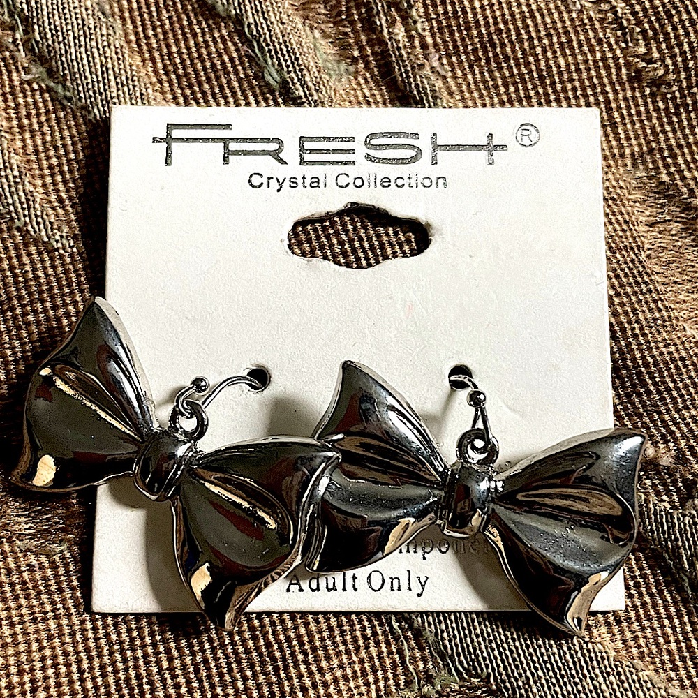 Silver bow tie earrings. One size.